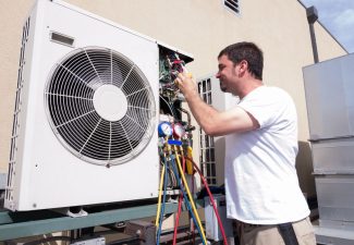 29491246 - hvac technician working on a mini-split condensing unit